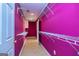 Walk-in closet with built-in shelving and storage solutions; painted pink at 230 Hidden Brook Trl, Fayetteville, GA 30215
