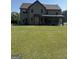 Large backyard with a covered patio and ample space for outdoor activities at 110 Broadwater Dr, Fayetteville, GA 30214