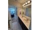 Well-lit bathroom with double sink vanity and access to a bedroom at 110 Broadwater Dr, Fayetteville, GA 30214