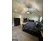 Well-lit bedroom featuring a large bed, dark furniture, and a ceiling fan at 110 Broadwater Dr, Fayetteville, GA 30214