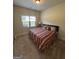 A comfortable bedroom with plush carpet and natural light from a large window at 110 Broadwater Dr, Fayetteville, GA 30214