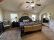 Spacious bedroom featuring a large bed and sitting area with an arched doorway to another room at 110 Broadwater Dr, Fayetteville, GA 30214