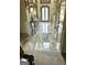 Grand foyer featuring marble tile flooring, elegant front door, and decorative console tables at 110 Broadwater Dr, Fayetteville, GA 30214