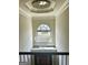 Bright foyer featuring a large chandelier and a half-moon window overlooking the front yard at 110 Broadwater Dr, Fayetteville, GA 30214