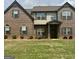 Inviting brick home featuring a manicured lawn and symmetrical design with a covered front porch at 110 Broadwater Dr, Fayetteville, GA 30214