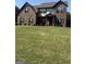 Beautiful brick home with a spacious, green lawn and symmetrical window design at 110 Broadwater Dr, Fayetteville, GA 30214
