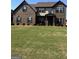 Charming two-story brick home boasts a large lawn and balanced facade at 110 Broadwater Dr, Fayetteville, GA 30214