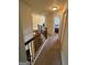 Upstairs hallway featuring bedrooms and access to a staircase at 110 Broadwater Dr, Fayetteville, GA 30214