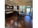 A modern kitchen featuring dark wood cabinets, granite countertops, and a glass-top dining table at 110 Broadwater Dr, Fayetteville, GA 30214