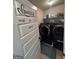 A modern laundry room featuring black front load washer and dryer at 110 Broadwater Dr, Fayetteville, GA 30214