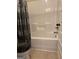 Clean bathtub and shower combination with gray patterned curtain at 110 Broadwater Dr, Fayetteville, GA 30214