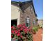 Brick home featuring red roses and a well-maintained lawn with a security camera at 110 Broadwater Dr, Fayetteville, GA 30214