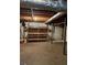 Unfinished basement with concrete floor, exposed ceiling, and wooden shelving for extra storage at 4528 Newcastle Cir, Lithonia, GA 30038