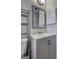 Bathroom featuring a gray vanity, mirror, storage, toilet, and sink at 9689 Pintail Trl, Jonesboro, GA 30238