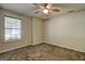 Bedroom with neutral carpet, ceiling fan, and a window at 9689 Pintail Trl, Jonesboro, GA 30238