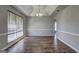 Bright dining room with coffered ceiling, light gray walls, wood laminate flooring, and a window at 9689 Pintail Trl, Jonesboro, GA 30238