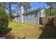 Back of the home showing the backyard, deck stairs, windows and wood fence at 9689 Pintail Trl, Jonesboro, GA 30238