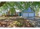 Inviting home with gray siding, brick accents, a well-manicured lawn, and a convenient two-car garage at 9689 Pintail Trl, Jonesboro, GA 30238