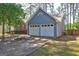 Spacious two-car garage showcasing painted siding, complemented by a double wide driveway at 9689 Pintail Trl, Jonesboro, GA 30238