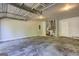 Spacious garage interior with concrete floors, overhead lighting and white walls at 9689 Pintail Trl, Jonesboro, GA 30238