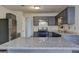 Updated kitchen with granite countertops, stainless steel appliances, and gray cabinetry at 9689 Pintail Trl, Jonesboro, GA 30238