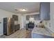 Modern kitchen with granite countertops, stainless steel refrigerator, and an overhead light at 9689 Pintail Trl, Jonesboro, GA 30238