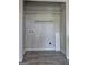 Empty laundry room with tile floors, shelving, electrical outlets, and washer-dryer hookups at 9689 Pintail Trl, Jonesboro, GA 30238