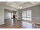 Bright living room open to dining room with fireplace, light gray walls and wood laminate flooring at 9689 Pintail Trl, Jonesboro, GA 30238