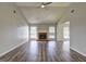 A spacious living room featuring vaulted ceilings, wood floors, and a fireplace at 9689 Pintail Trl, Jonesboro, GA 30238