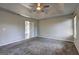 Large main bedroom featuring carpet, a ceiling fan, and an ensuite bathroom at 9689 Pintail Trl, Jonesboro, GA 30238