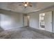 Spacious main bedroom with carpet, tray ceiling, ceiling fan, and an ensuite bathroom at 9689 Pintail Trl, Jonesboro, GA 30238