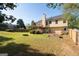 Large backyard with wooden fence, a deck, and a fire pit perfect for outdoor entertaining at 3540 Owl Brow Ct, Cumming, GA 30028