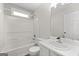 Bathroom featuring tub/shower combination, single sink and vanity, and a window at 3540 Owl Brow Ct, Cumming, GA 30028