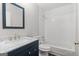 Bathroom featuring a granite vanity top and a shower over tub with white tiles at 3540 Owl Brow Ct, Cumming, GA 30028