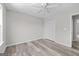A cozy bedroom with neutral paint, wood-look floors, a ceiling fan, and a closet at 3540 Owl Brow Ct, Cumming, GA 30028