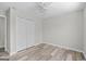 Clean bedroom featuring neutral walls, ceiling fan, and closet space at 3540 Owl Brow Ct, Cumming, GA 30028