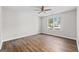 Bright bedroom with hardwood floors, ceiling fan, and large window at 3540 Owl Brow Ct, Cumming, GA 30028