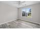 Bright bedroom with large window, neutral walls, and ceiling fan at 3540 Owl Brow Ct, Cumming, GA 30028