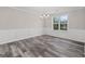 Bright dining room with wainscoting, natural light, and wood-look floors at 3540 Owl Brow Ct, Cumming, GA 30028