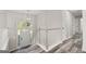 Elegant foyer with wood-look floors, white door, and modern chandelier lighting at 3540 Owl Brow Ct, Cumming, GA 30028