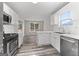 Updated kitchen boasts stainless appliances and a view of the outdoor living space at 3540 Owl Brow Ct, Cumming, GA 30028