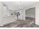 Open concept kitchen with stainless steel appliances and white cabinets at 3540 Owl Brow Ct, Cumming, GA 30028