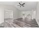 Spacious living room with vaulted ceiling, fan, and wood-look floors at 3540 Owl Brow Ct, Cumming, GA 30028