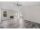 Bright living room with a fireplace, and wood-look floors, offering a cozy feel at 3540 Owl Brow Ct, Cumming, GA 30028