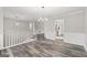 Open-concept living area with stylish floors, staircase, and modern lighting at 3540 Owl Brow Ct, Cumming, GA 30028