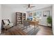 Well-lit office with wood-look flooring, bookcase, and a chair and desk at 3540 Owl Brow Ct, Cumming, GA 30028