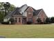 Charming two-story brick home with well-maintained landscaping and a lush front lawn at 480 Meadow Sage Ln, Fayetteville, GA 30214