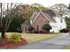 A beautiful brick home with a side entry garage and manicured landscaping, creating a welcoming curb appeal at 480 Meadow Sage Ln, Fayetteville, GA 30214