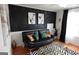 A modern seating area with a black sofa, artwork, and graphic rug at 480 Meadow Sage Ln, Fayetteville, GA 30214