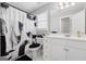 Bright bathroom featuring a white vanity, toilet, and a shower/tub combo with a stylish black and white shower curtain at 1570 Woodberry Run Dr, Snellville, GA 30078